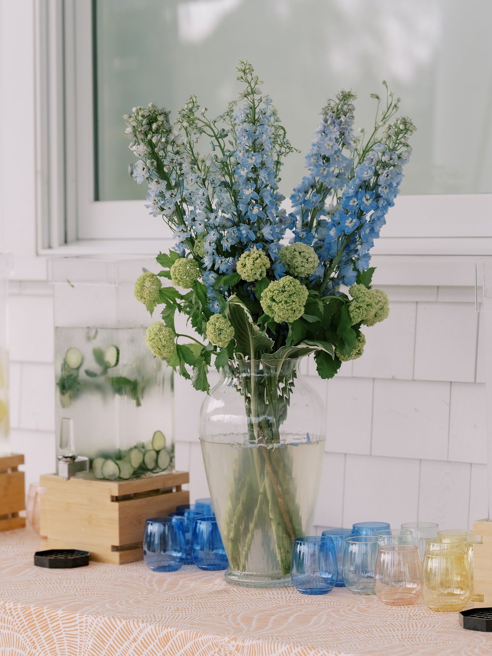 blue and yellow flowers sit with vintage glassware at The Country Club of New Canaan