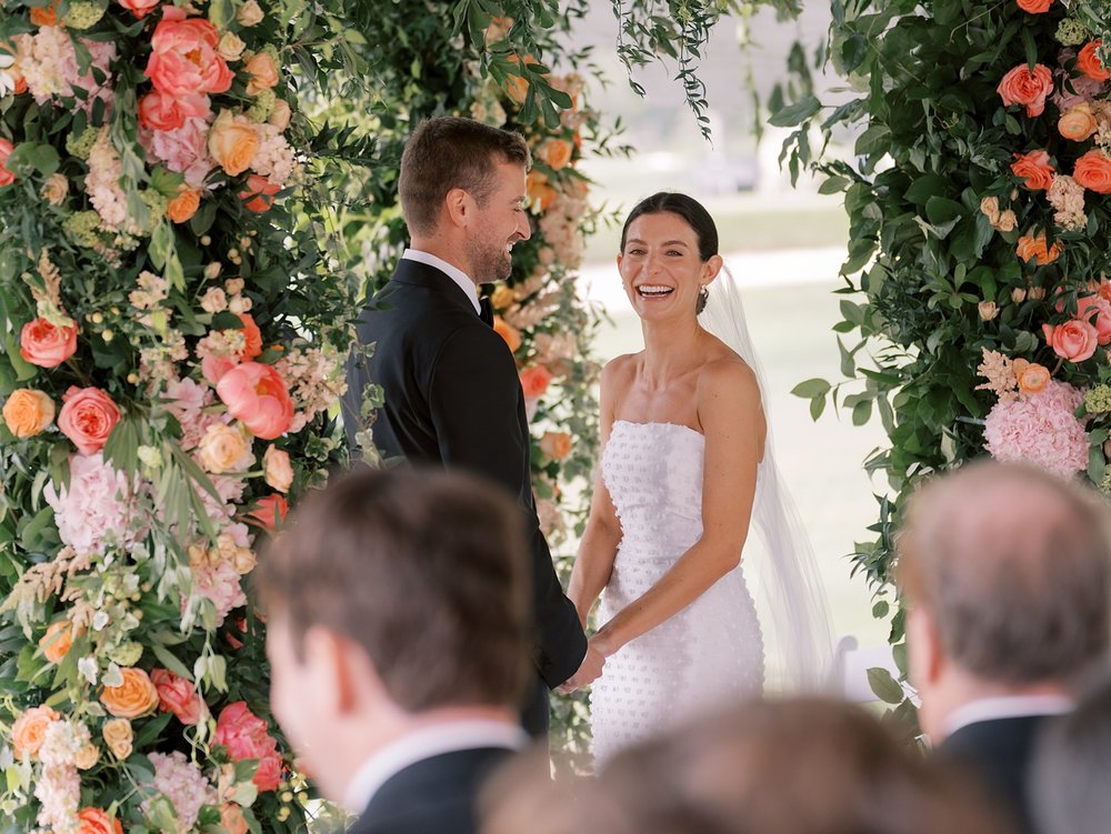 bride looks at guests laughing during The Country Club of New Canaan wedding ceremony 