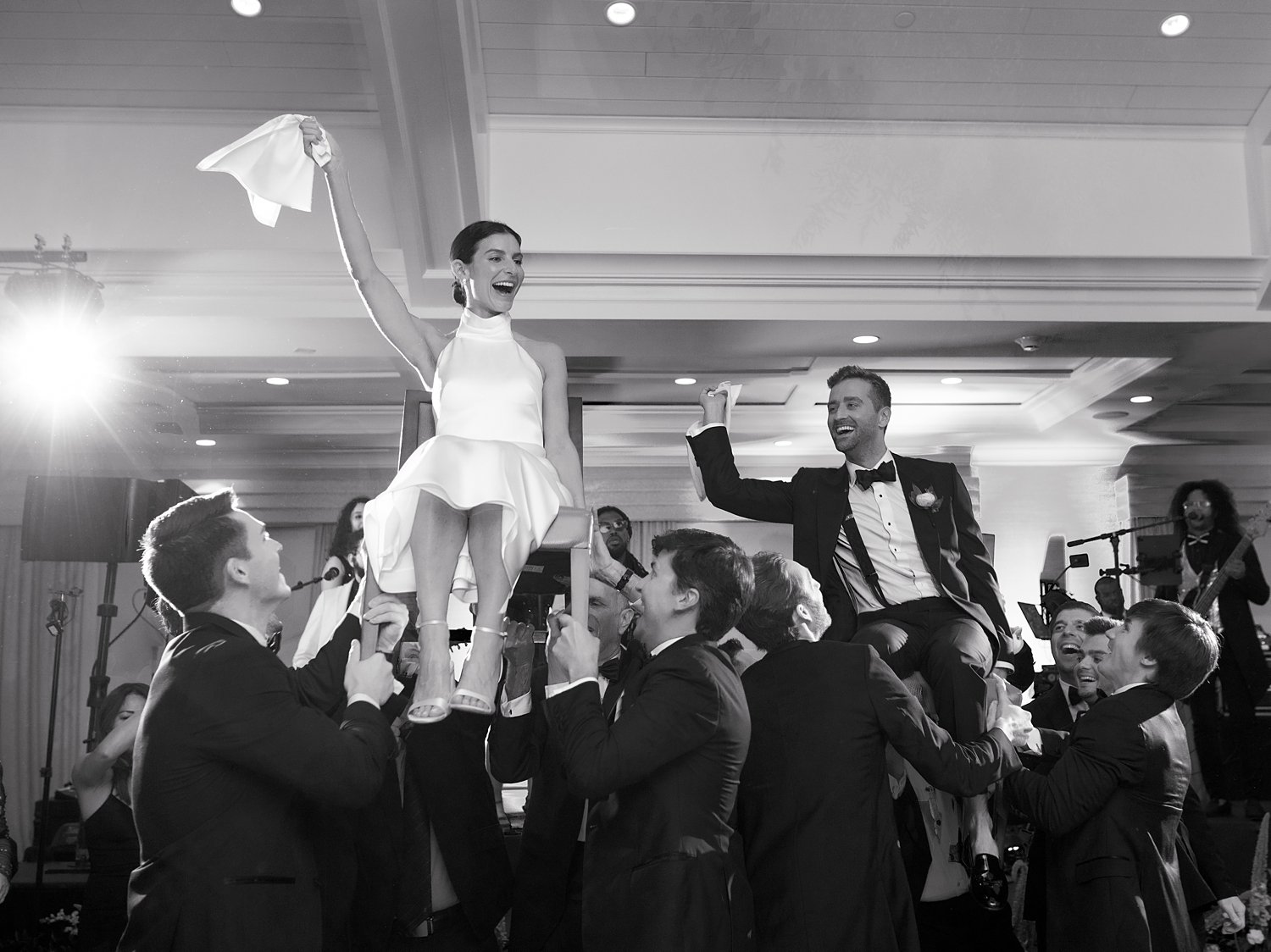 guests lift up bride twirling napkin at New Canaan wedding reception