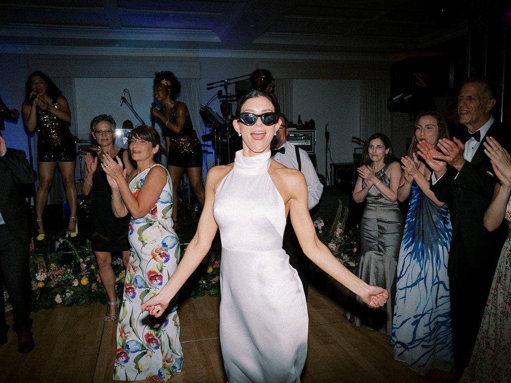 bride dances in sunglasses during New Canaan wedding reception