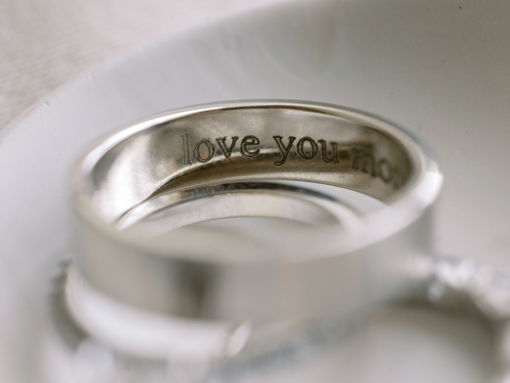 silver wedding band with "love you" engraved inside 