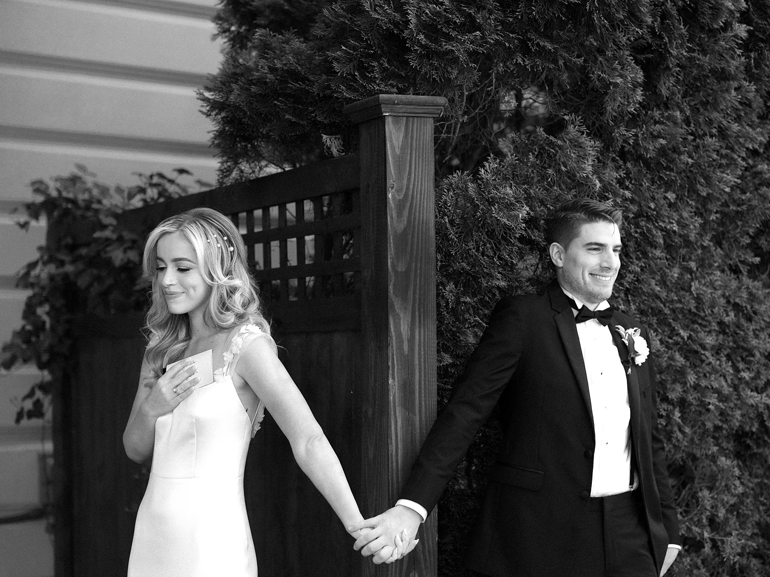 bride and groom have first touch around gate inside the Ashford Estate