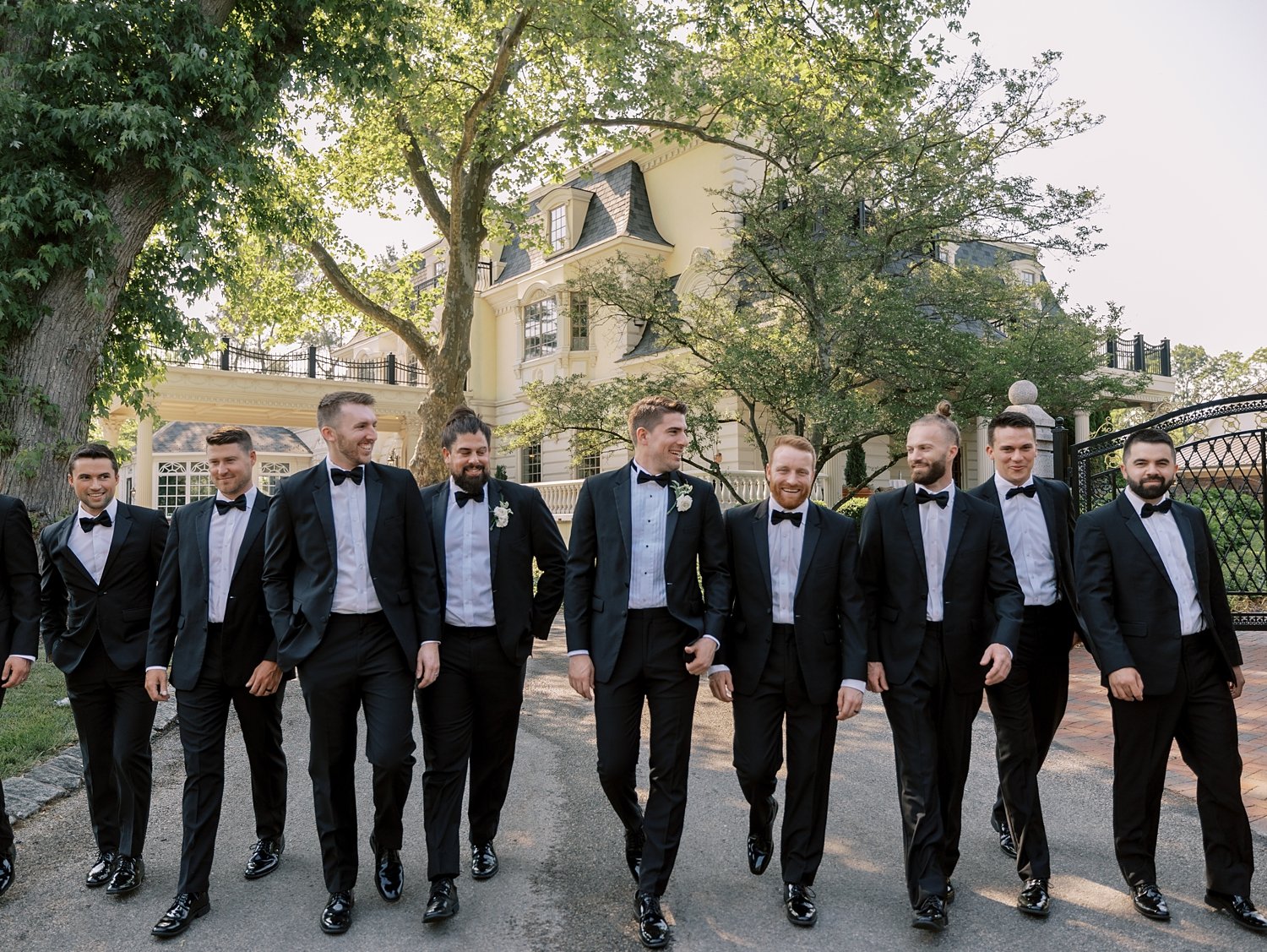 groom and groomsmen walk at the Ashford Estate