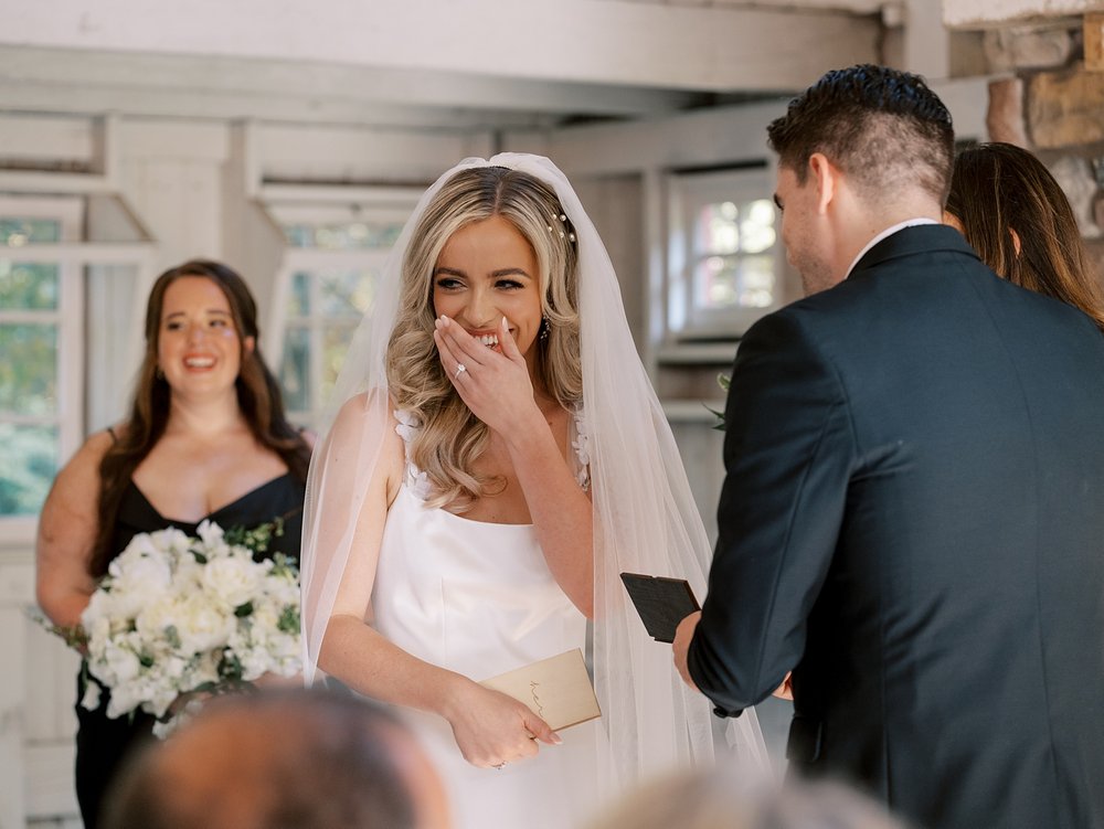 bride laughs during wedding ceremony at the Ashford Estate