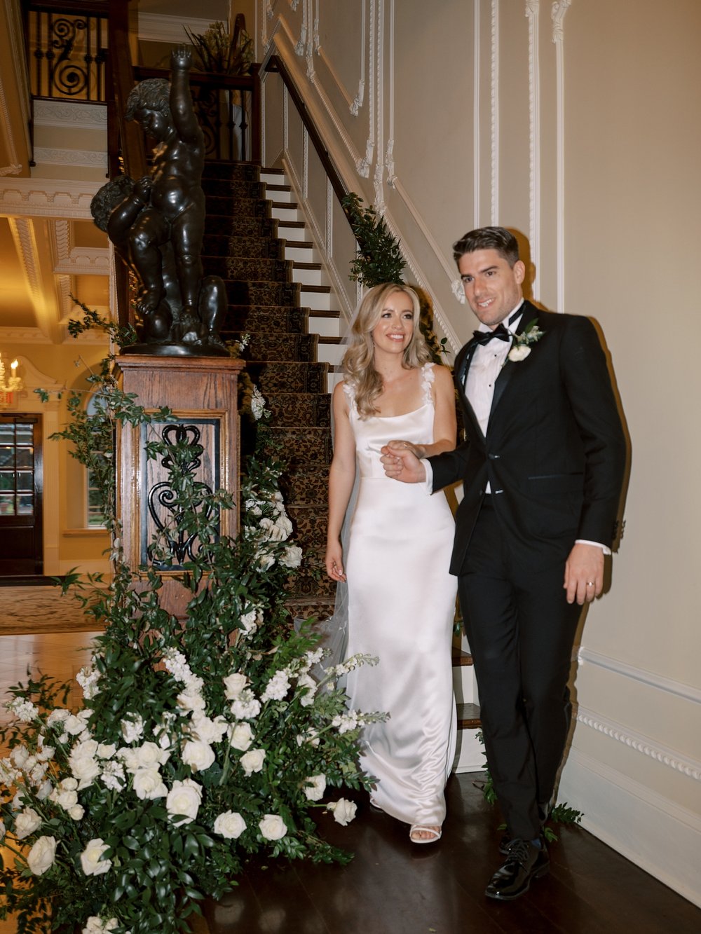bride and groom walk down steps inside the Ashford Estate