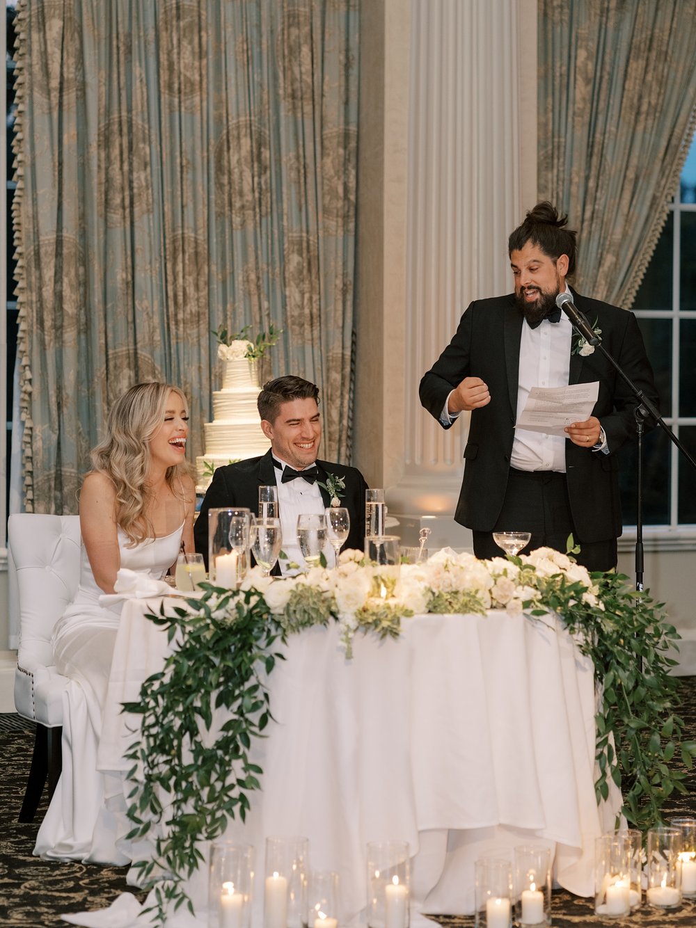 newlyweds listen to speeches during NJ wedding reception at the Ashford Estate