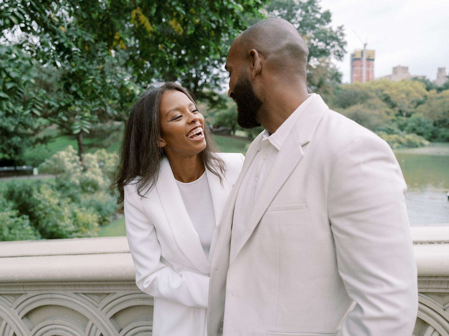 wife laughs up at husband during Central Park anniversary portraits in NYC