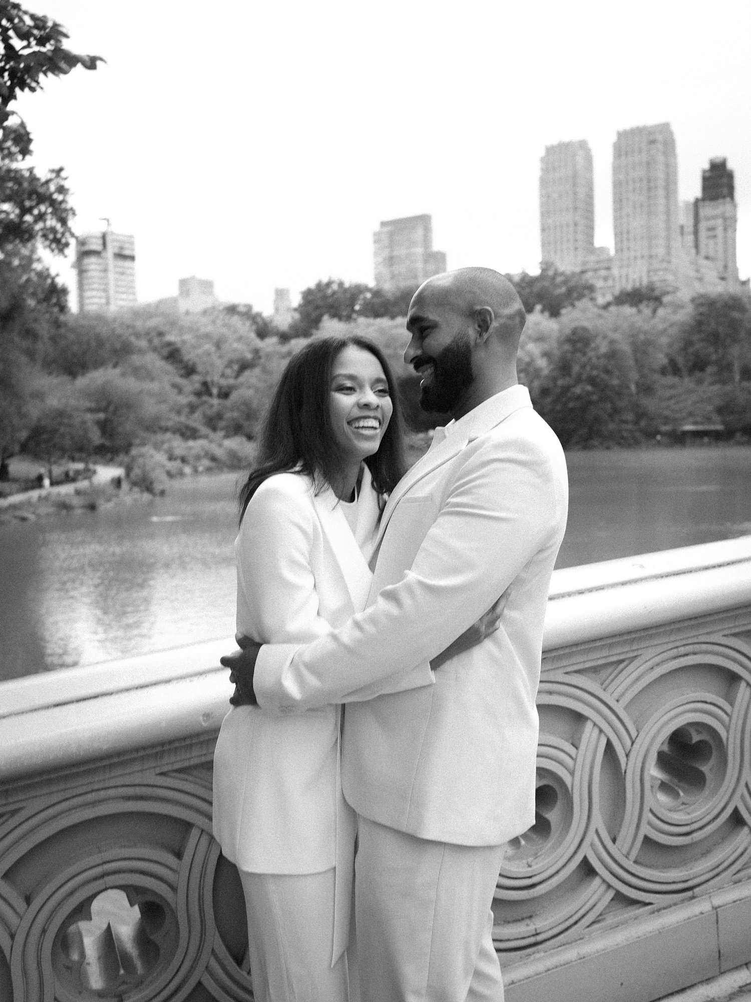 married couple hug laughing during Central Park anniversary portraits in NYC