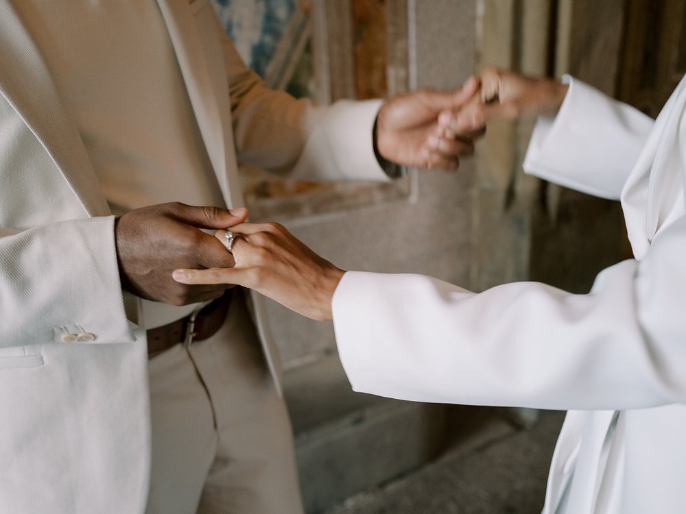 married couple holds hands dancing under staircase inside Central Park