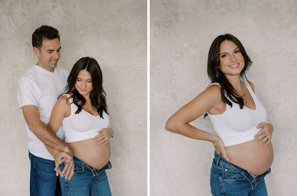 married couple poses together holding mom's bump during studio maternity portraits in New York City