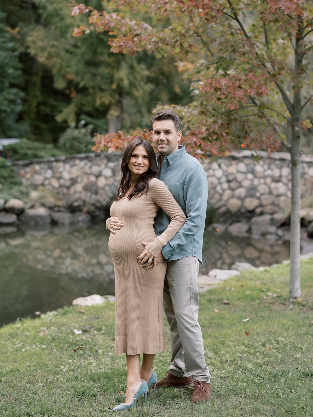 married couple hugs in Binney Park during fall maternity session in New York City