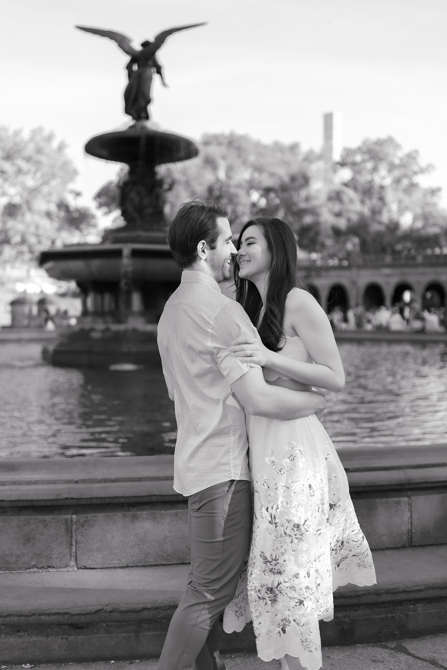 engaged couple hugs by Bethesda Fountain during engagement session