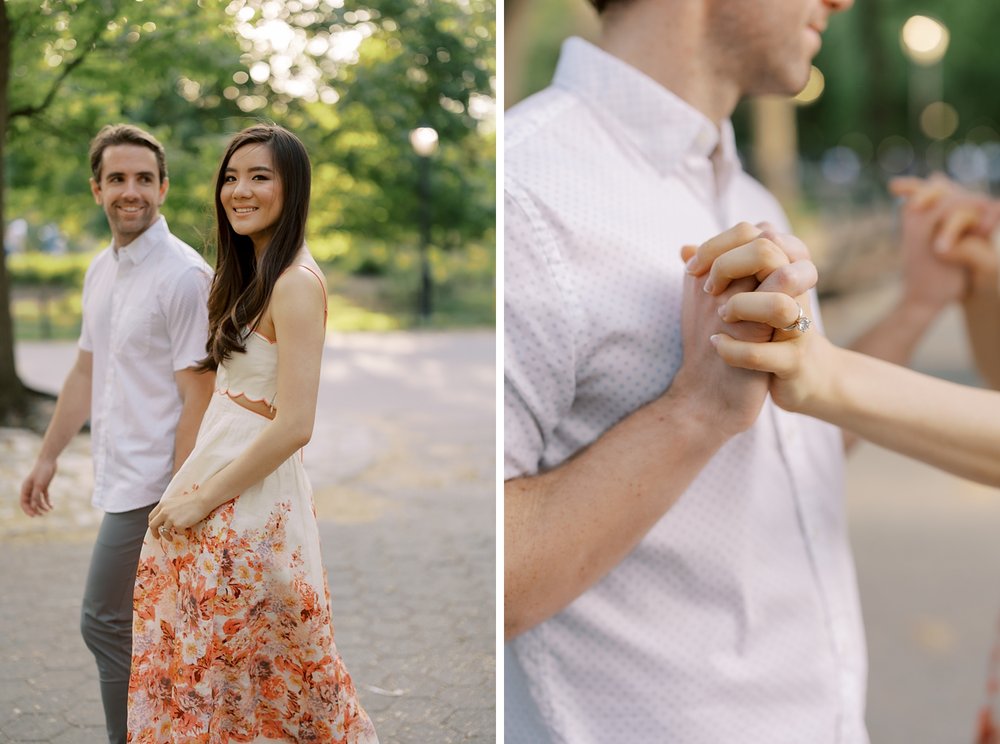 couple holds hands walking through Central Park