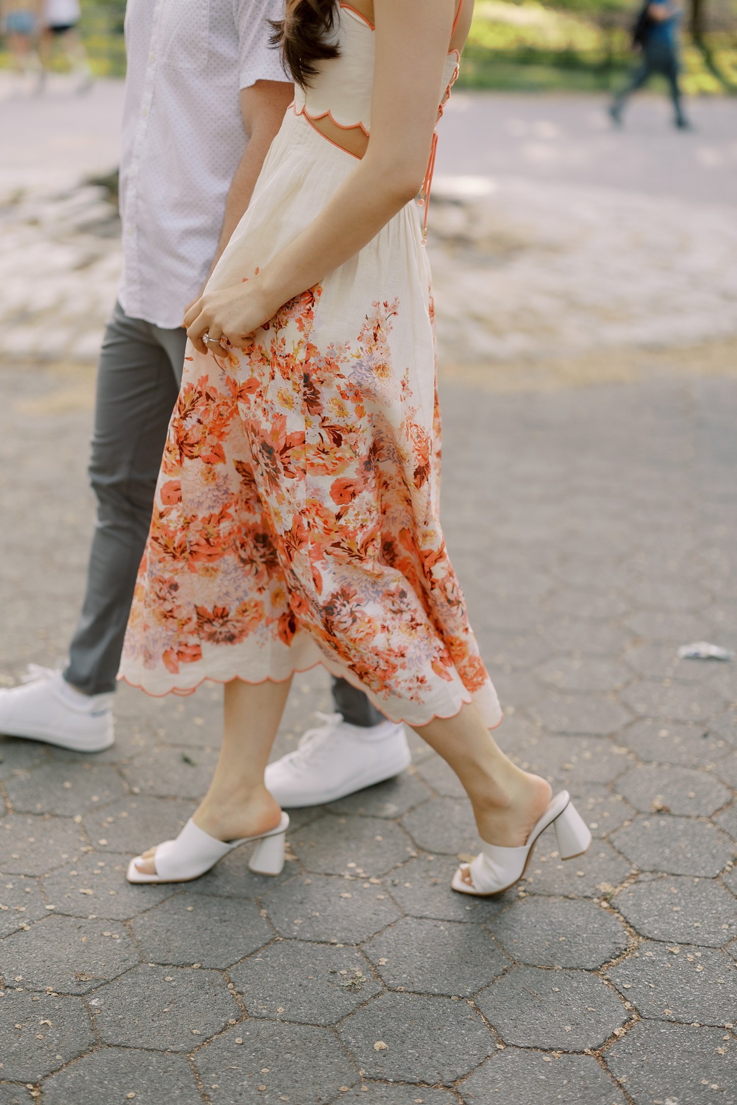 woman walks with fiancee twirling skirt of Zimmerman cocktail dress