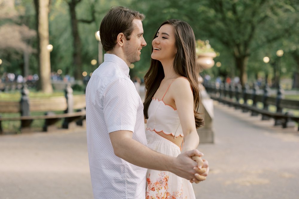 engaged couple stands together inside Central Park during engagement session