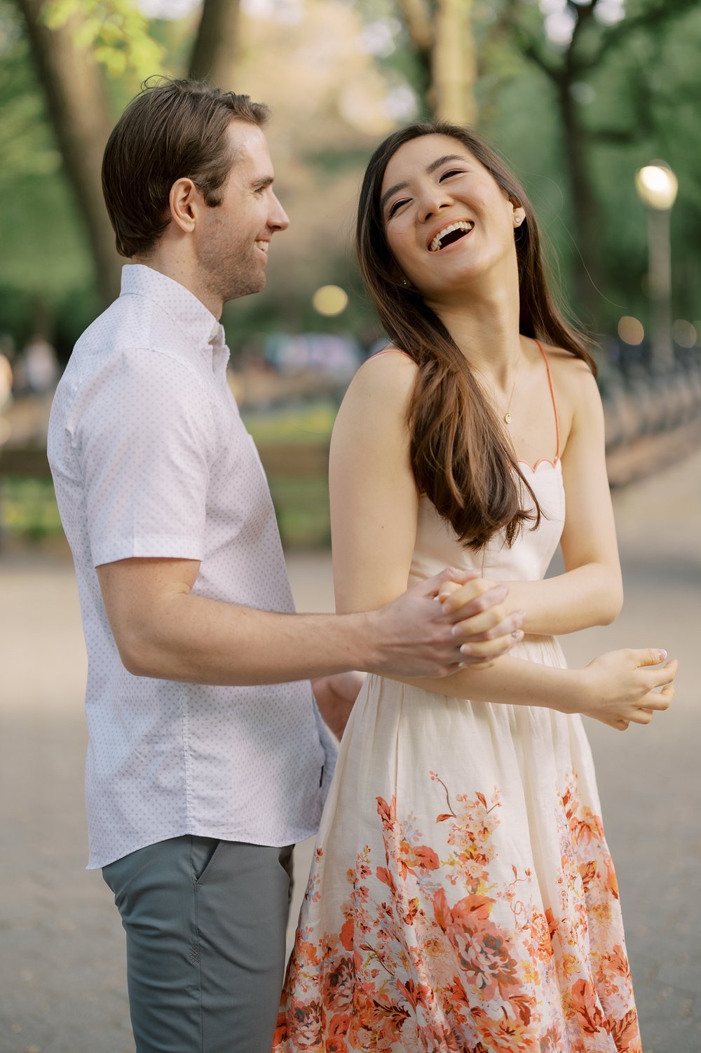 man and woman dance during NYC engagement session in Central Park