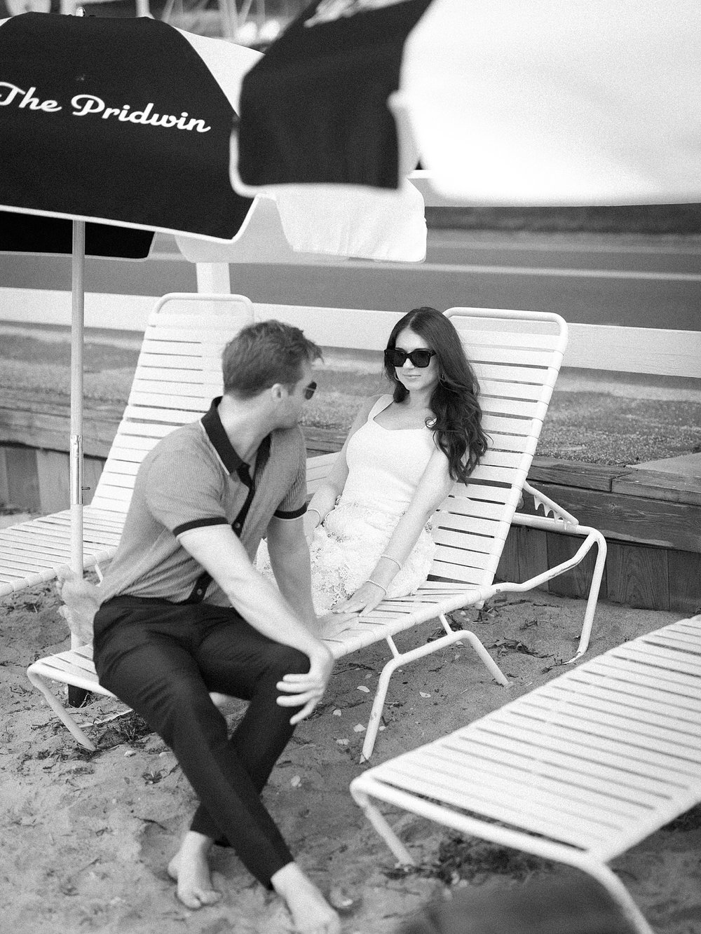 couple sits in pool chairs at the Pridwin on Shelter Island NY talking