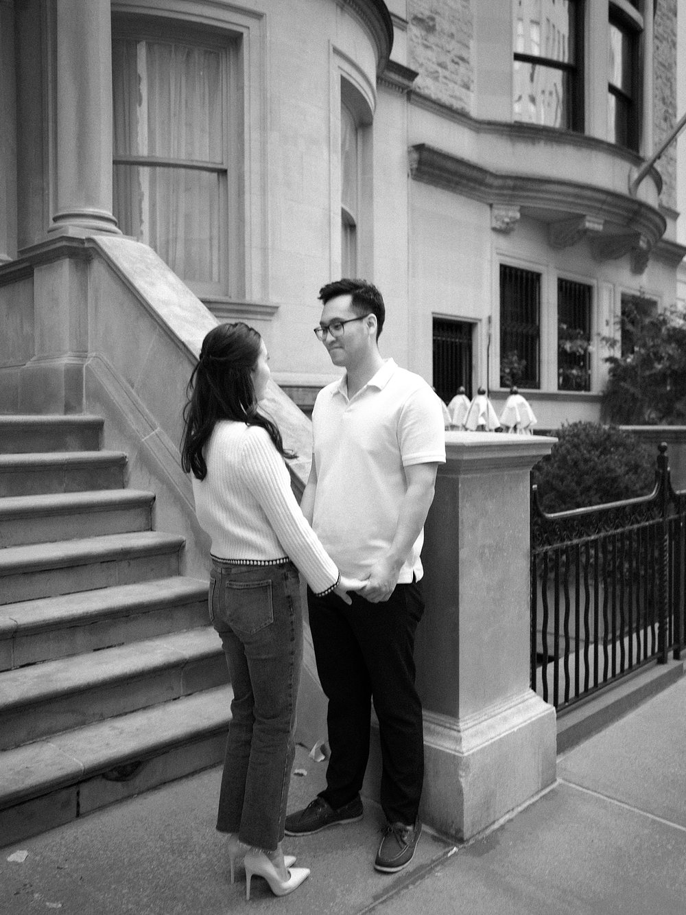 engaged couple talks on street in the Upper East Side