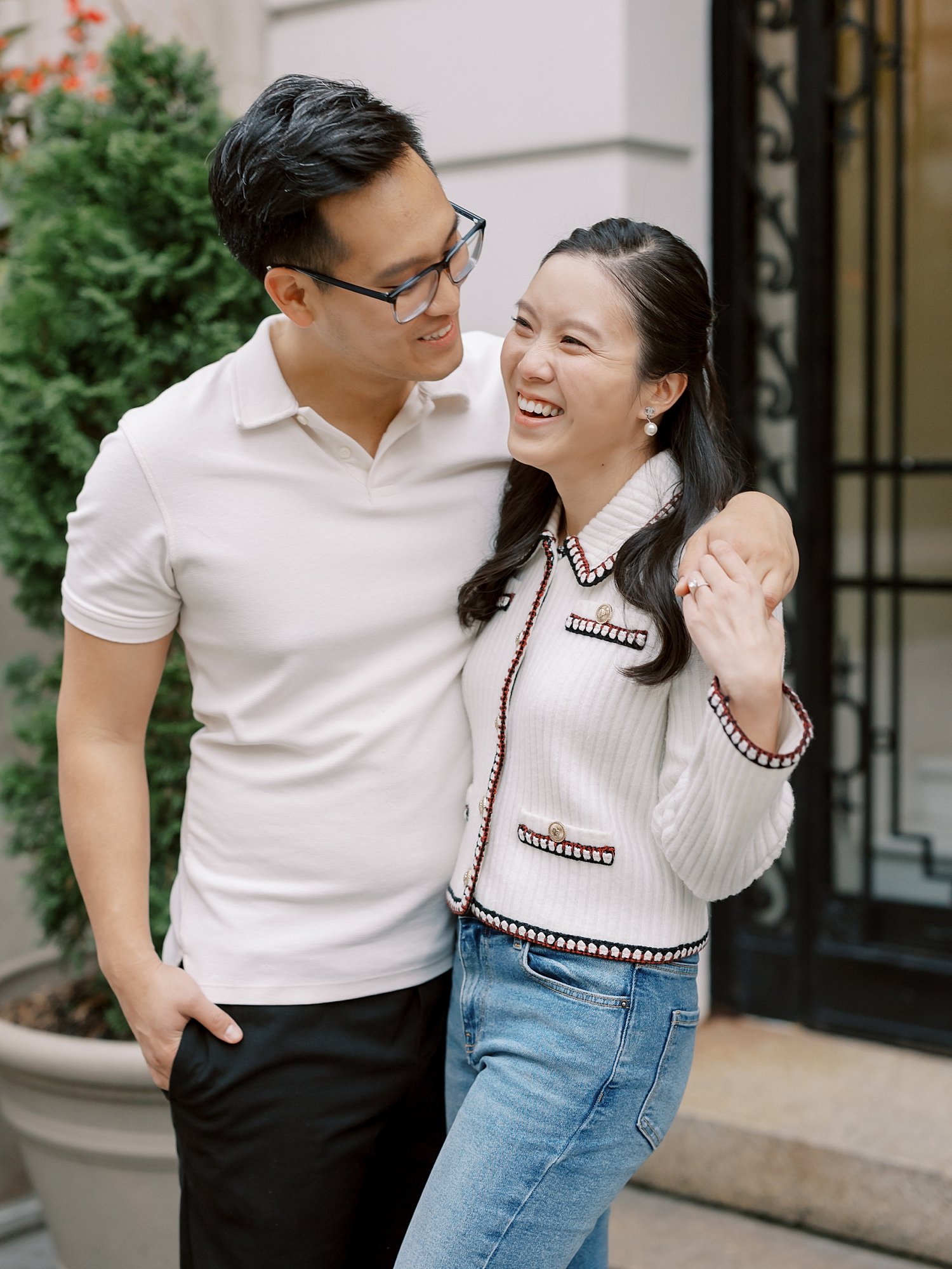 man puts arm around woman's shoulders hugging her