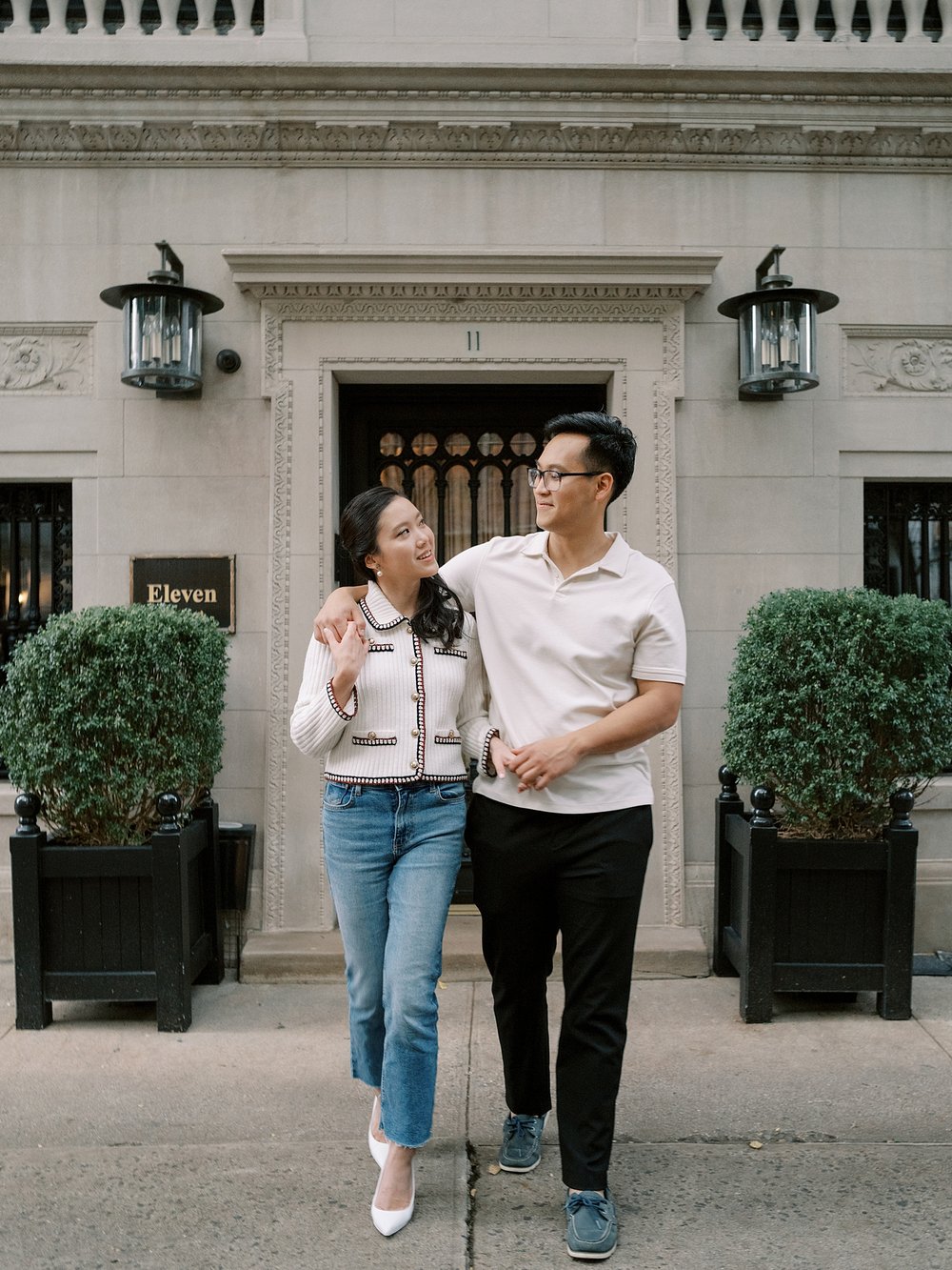 couple walks down street on the Upper East Side in NYC