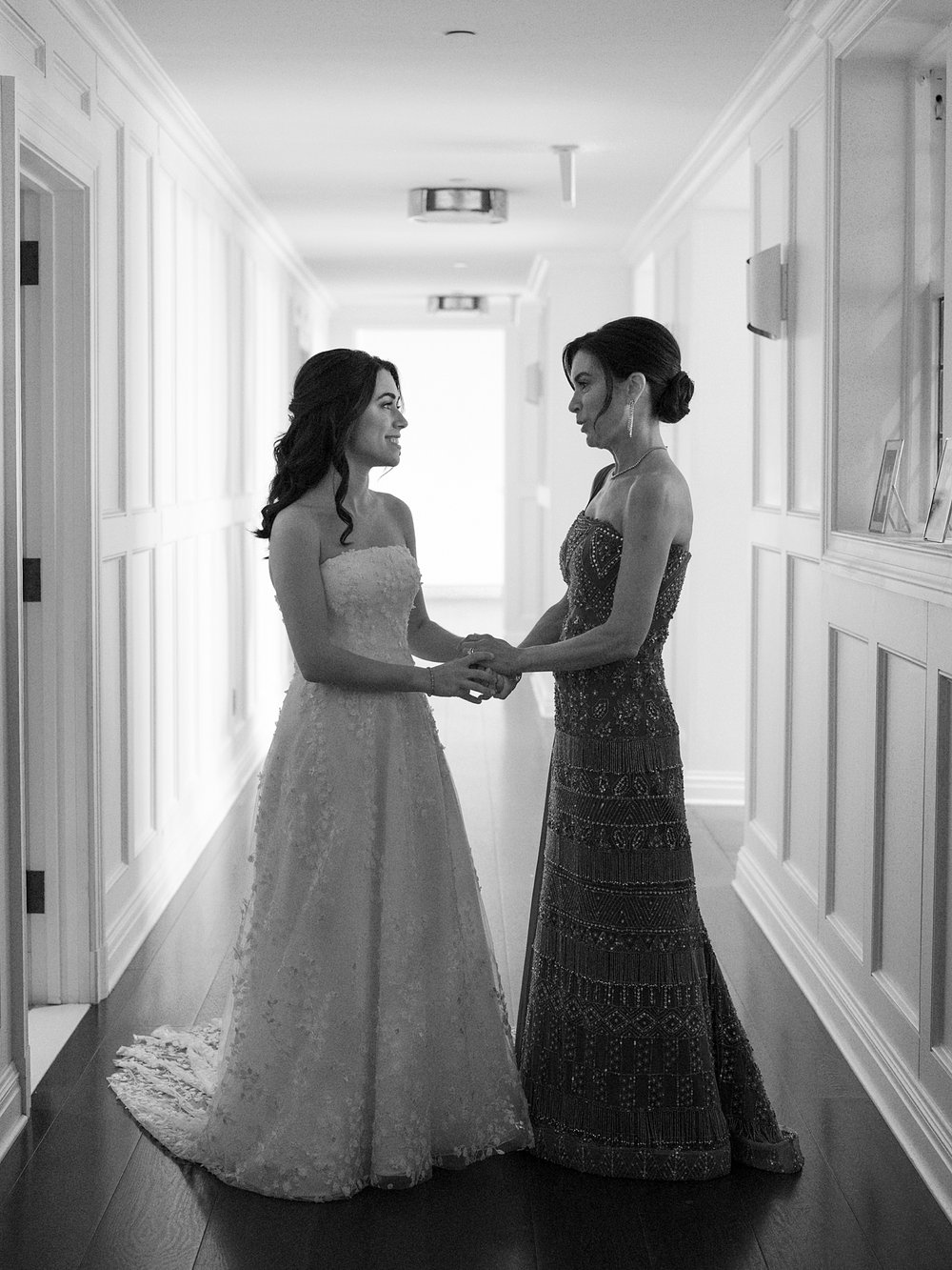 bride stands in hallway with mother inside the Mansion at Natirar