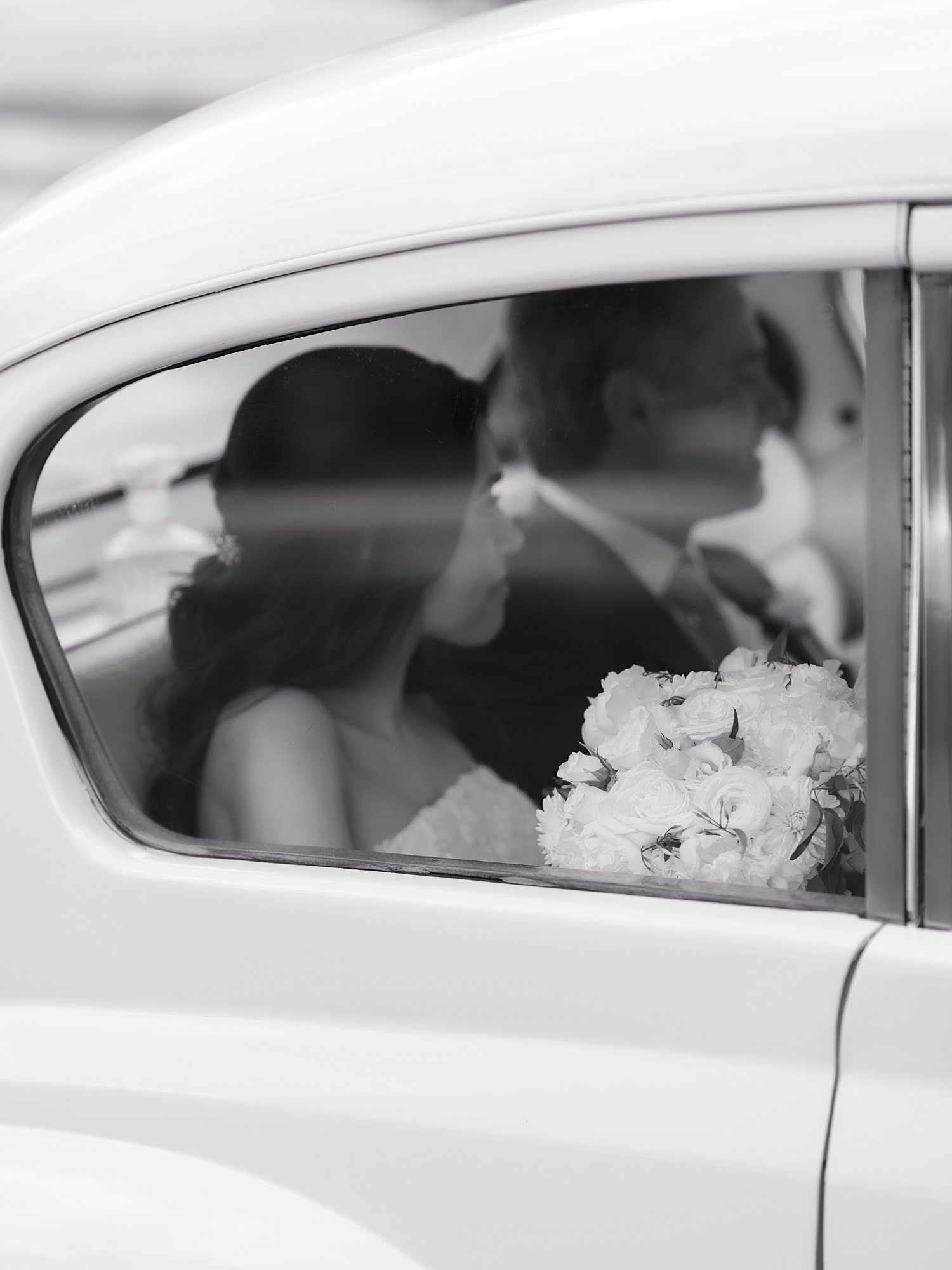bride rides in classic white car with father