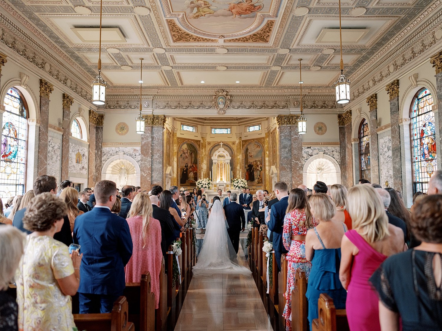bride walks down aisle with father in chapel at the Villa Walsh Academy
