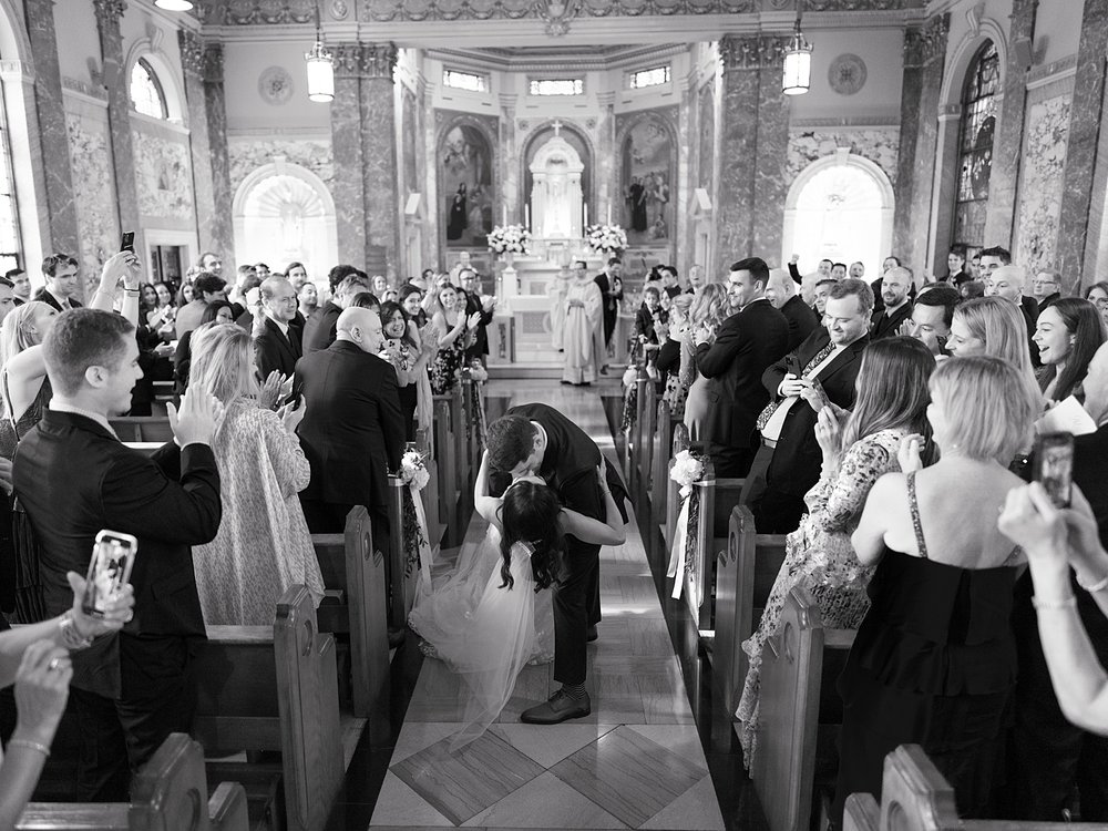 newlyweds kiss leaving ceremony inside the chapel at the Villa Walsh Academy