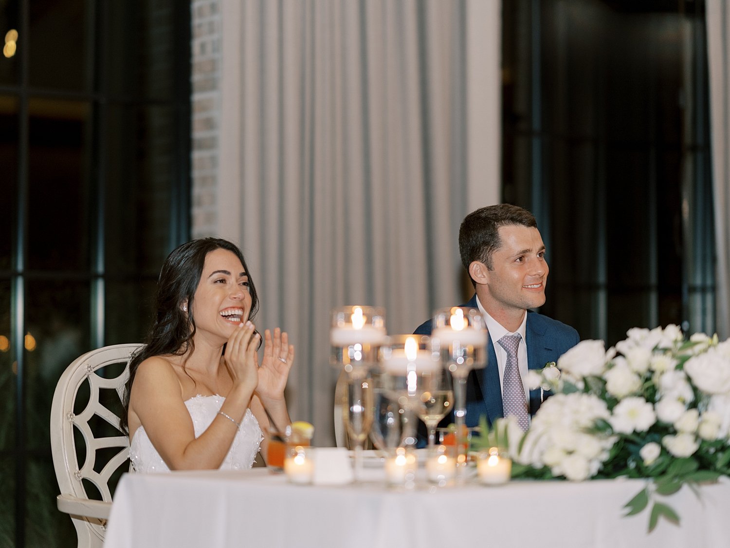 bride and groom laugh during toasts at NJ wedding reception