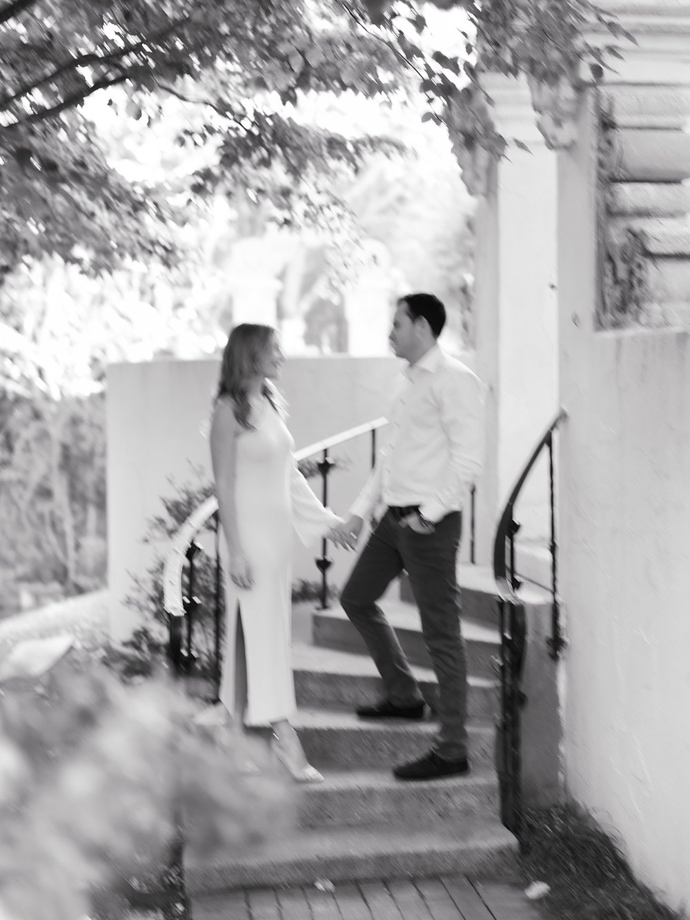 man and woman pose on steps at the Vanderbilt Museum