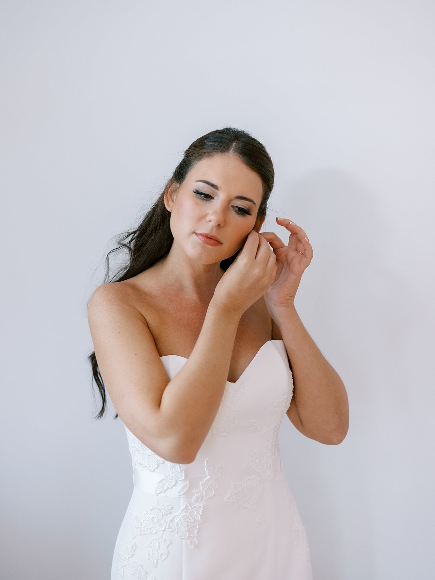 bride adjusts earrings before wedding at the Pridwin