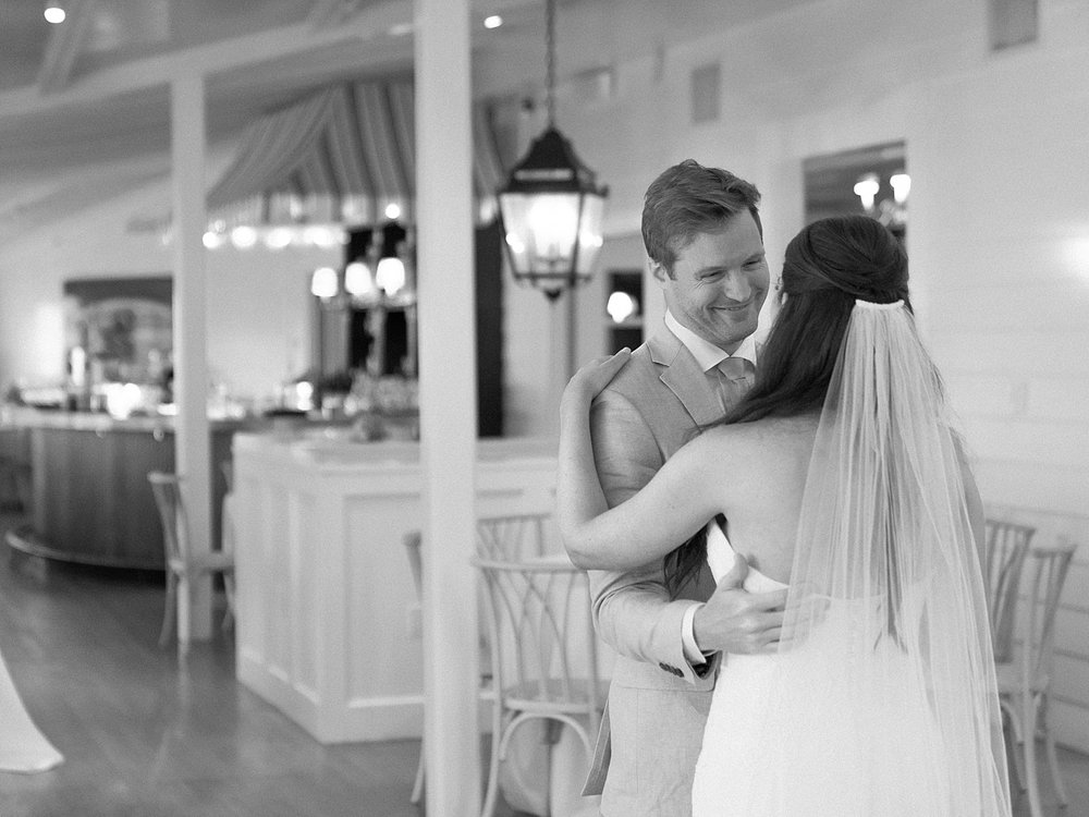groom hugs bride during first look inside bar at the Pridwin