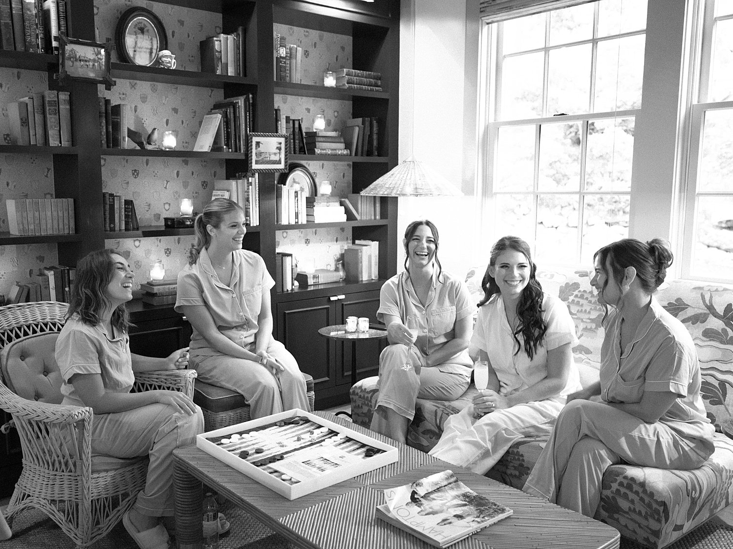 bride and bridesmaids laugh sitting in lobby of the Pridwin Hotel