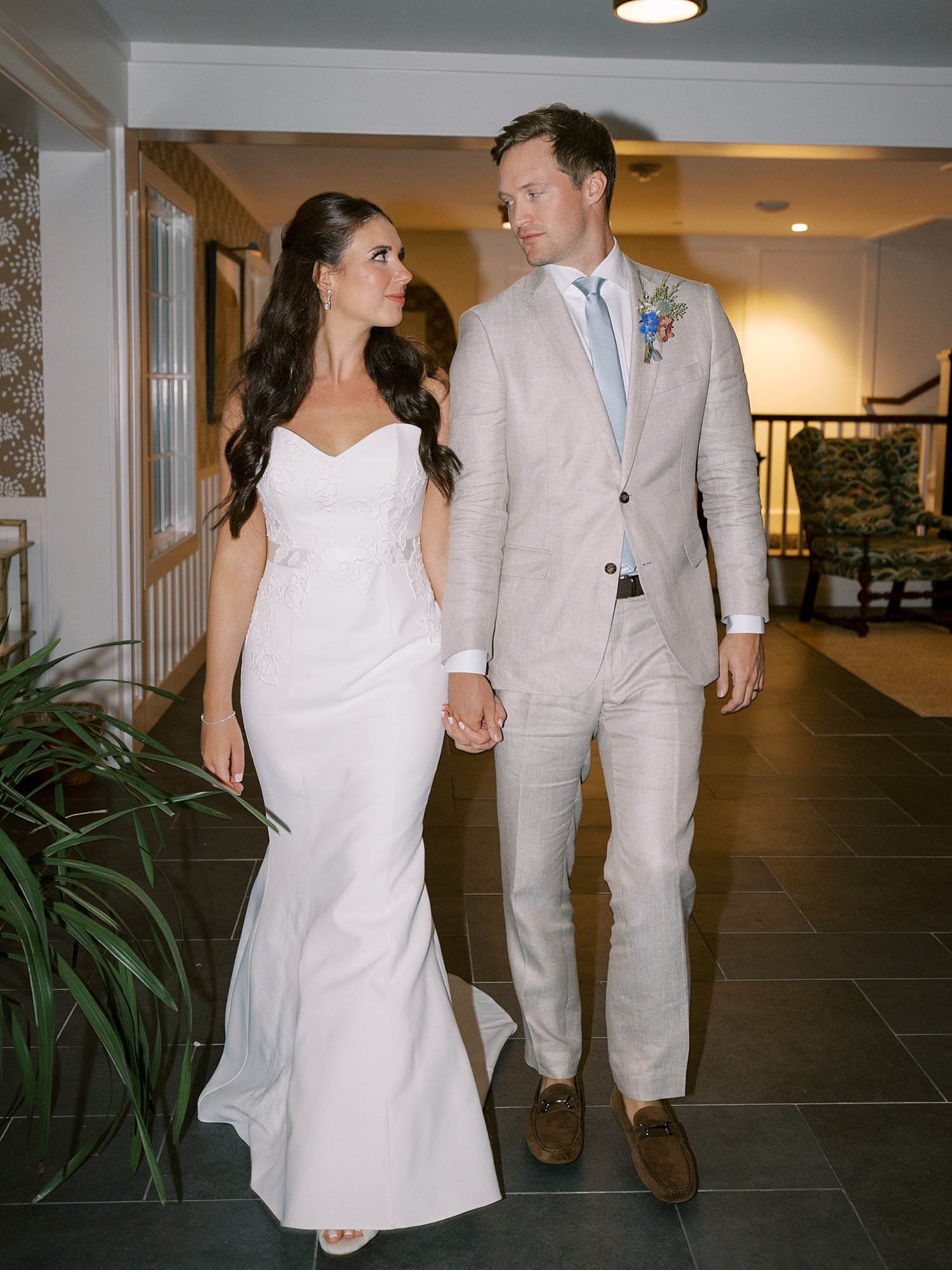 bride and groom hold hands entering reception at the Pridwin