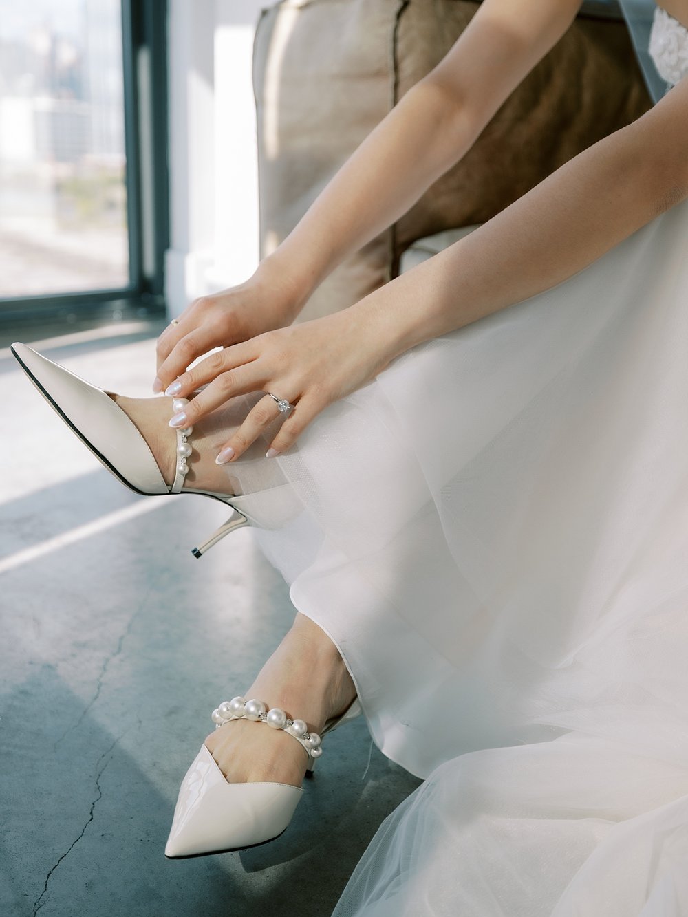 bride adjusts shoes on Brooklyn NY wedding day