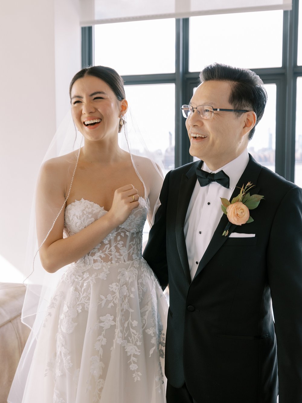 bride laughs with father during first look at the Wythe Hotel in Brooklyn NY