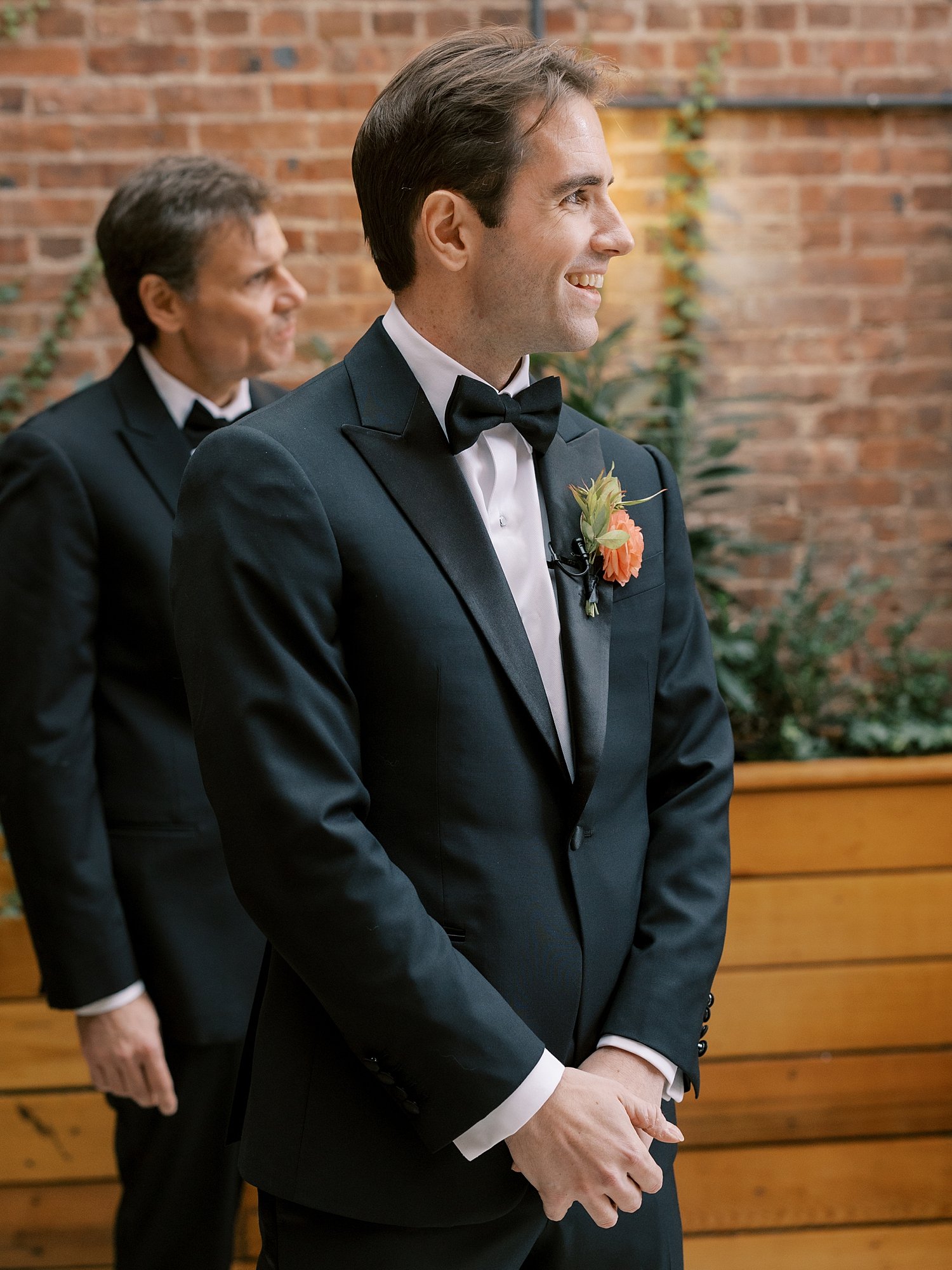 groom watches bride walk down aisle for ceremony at the Wythe Hotel