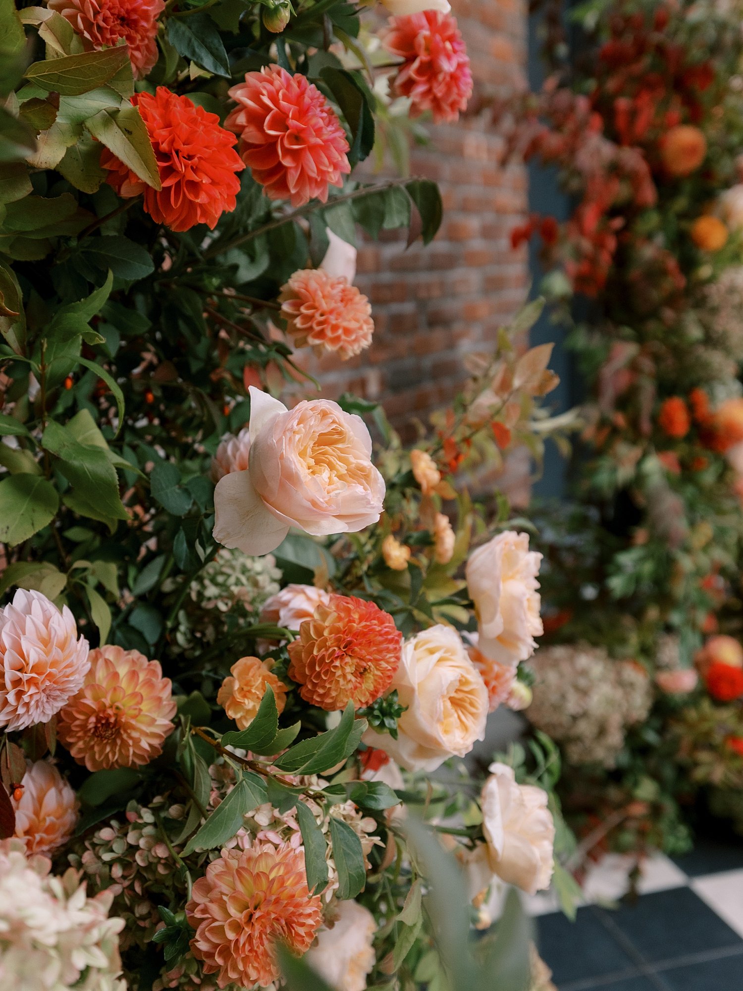 roses hang on wall for fall wedding ceremony at the Wythe Hotel