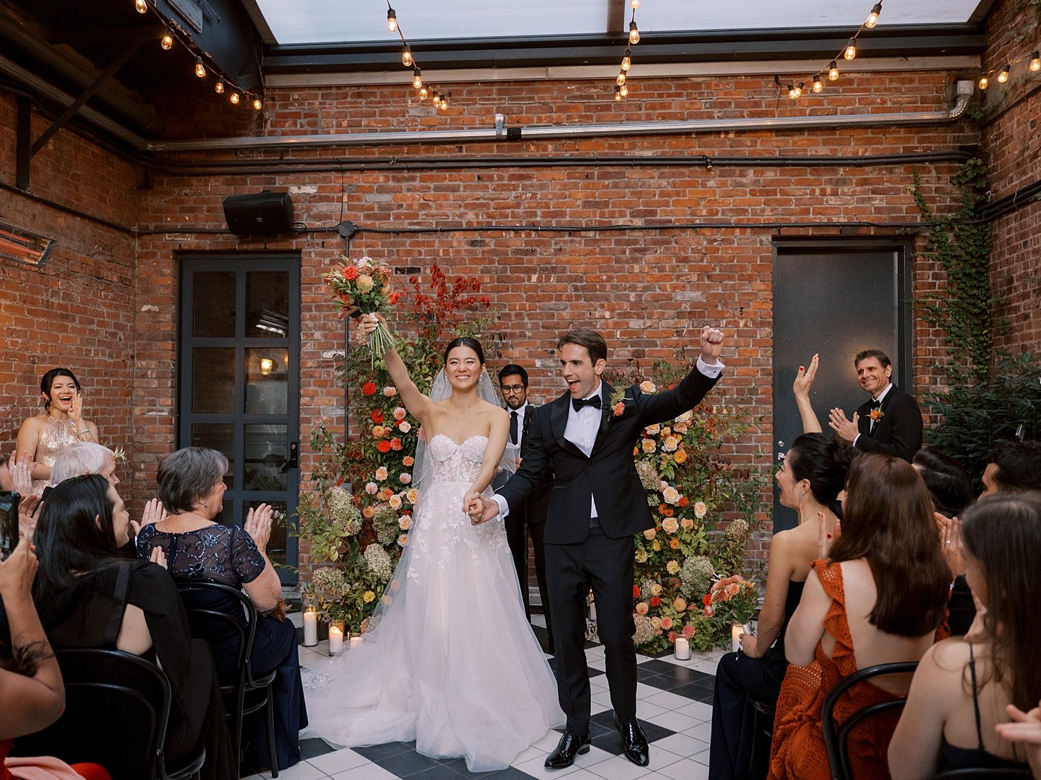 newlyweds cheer at floral installations at the Wythe Hotel