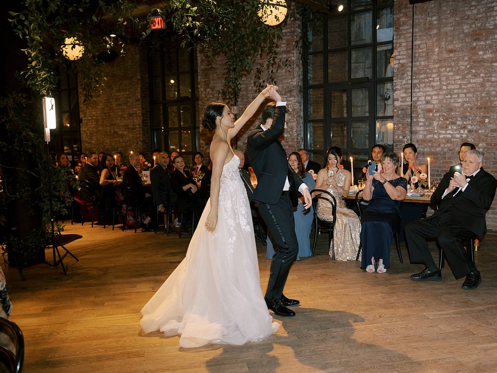groom leads bride onto dance floor during Brooklyn NY wedding reception