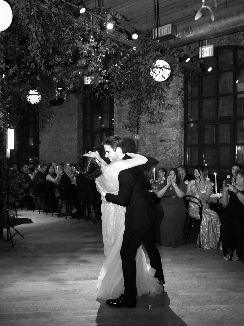 newlyweds kiss on dance floor during Brooklyn NY wedding reception