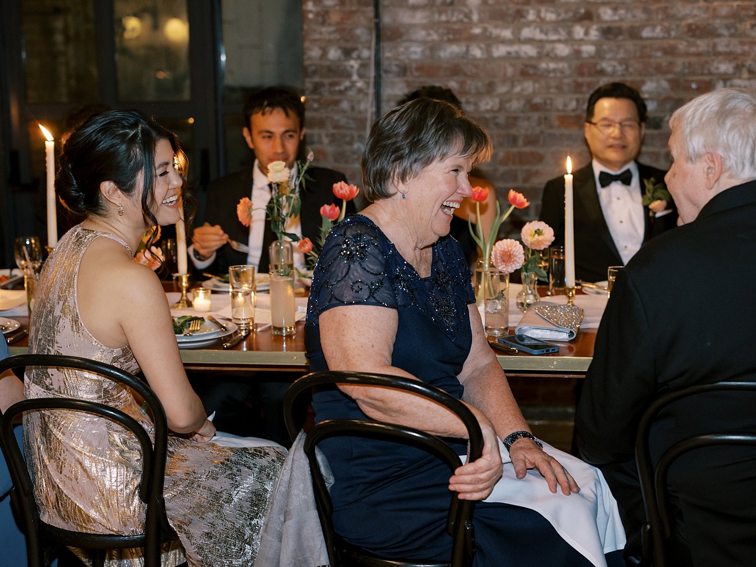 guests laugh at toasts during Brooklyn NY wedding reception