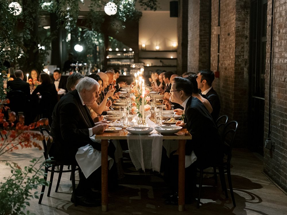 guests eat dinner with candle light during Brooklyn NY wedding reception