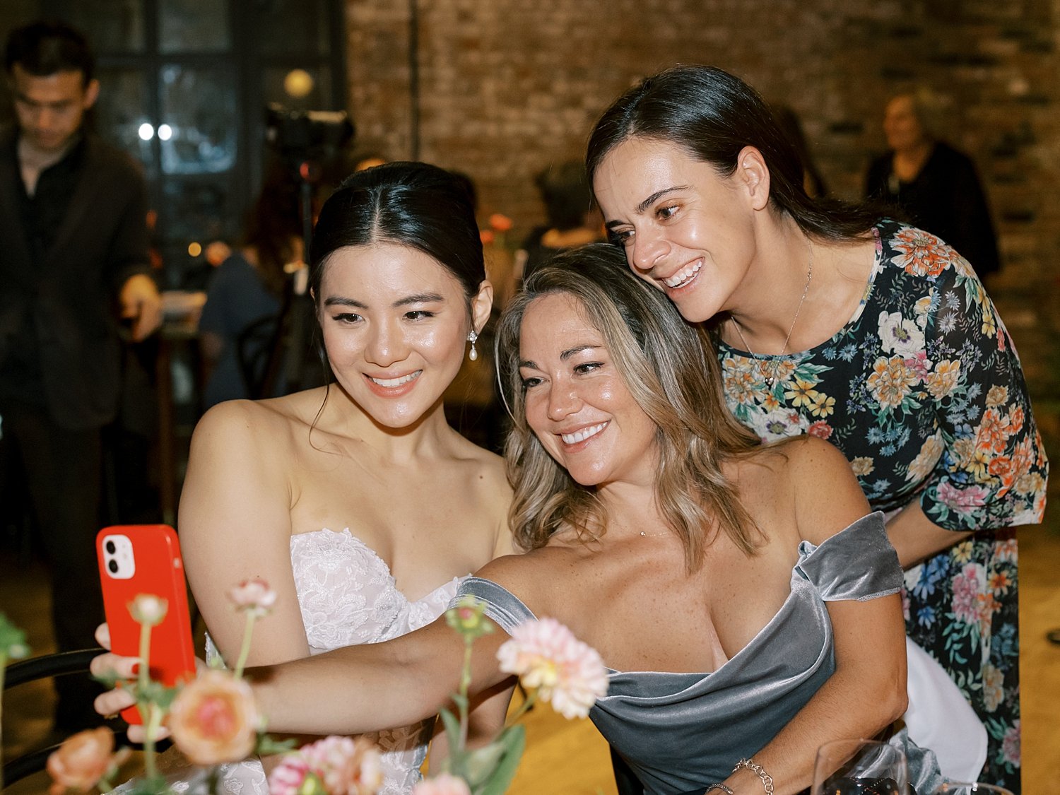 bride and guests take selfie during Brooklyn NY wedding reception