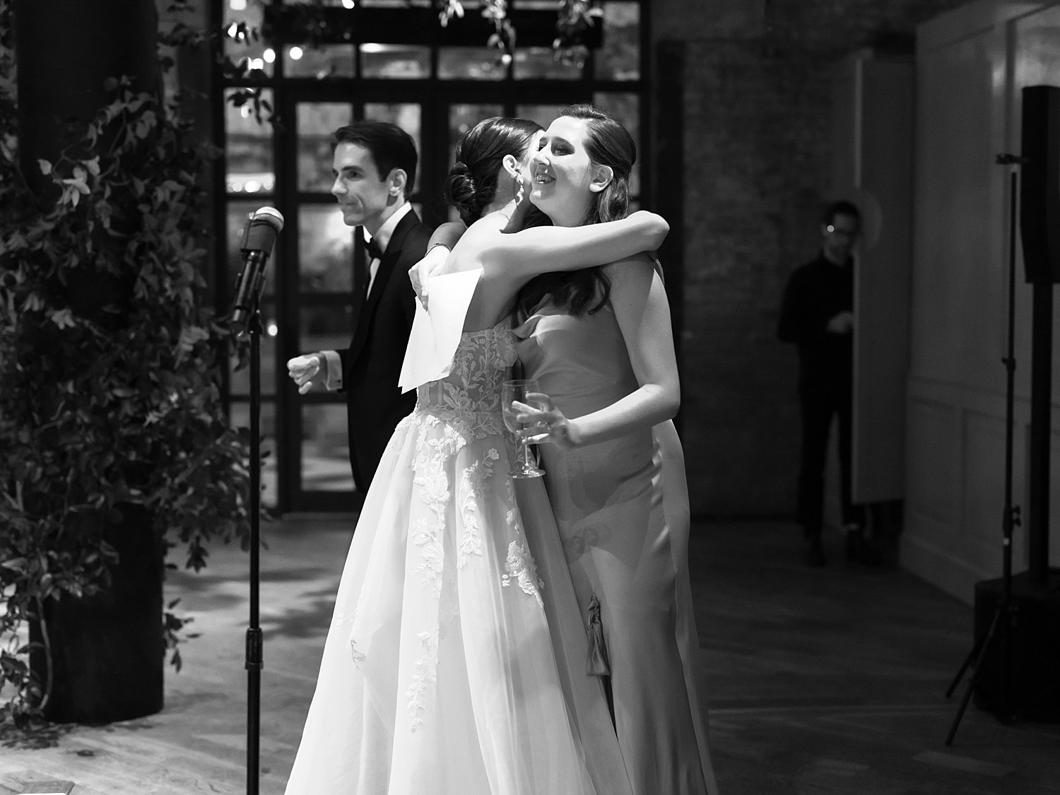 bride hugs bridesmaid during Brooklyn NY wedding reception