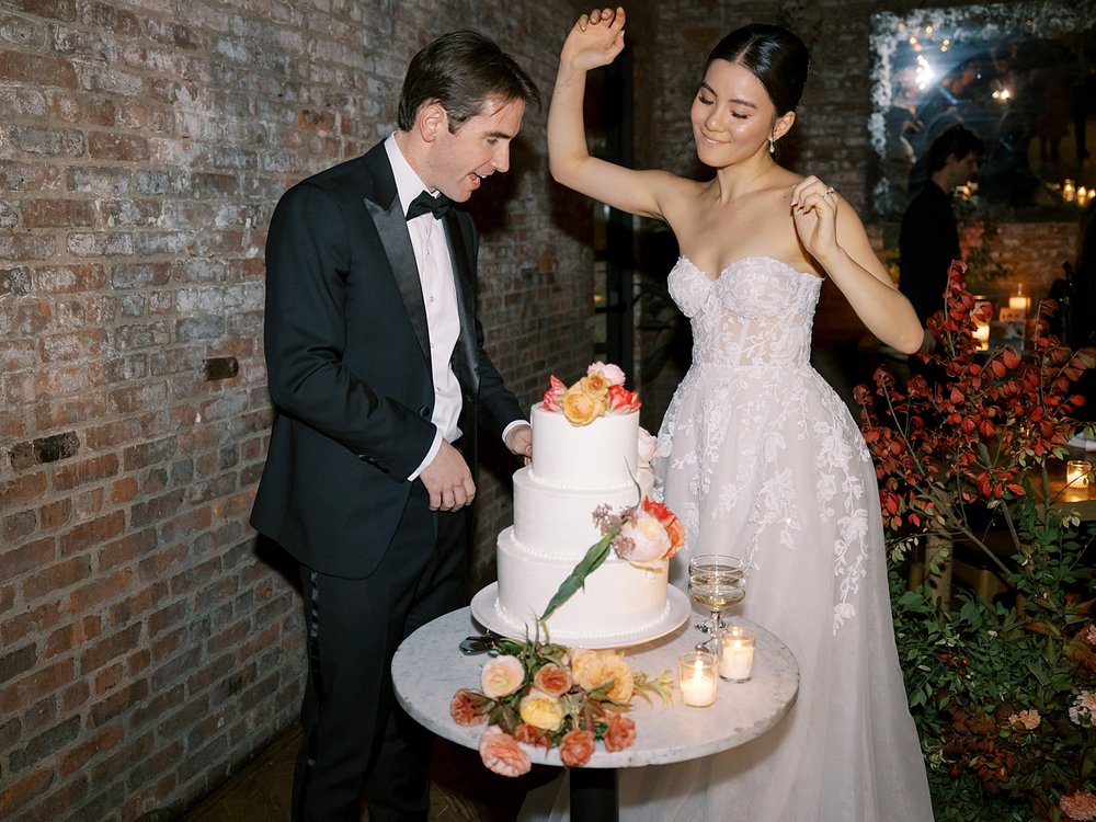 newlyweds cut cake during Brooklyn NY wedding reception