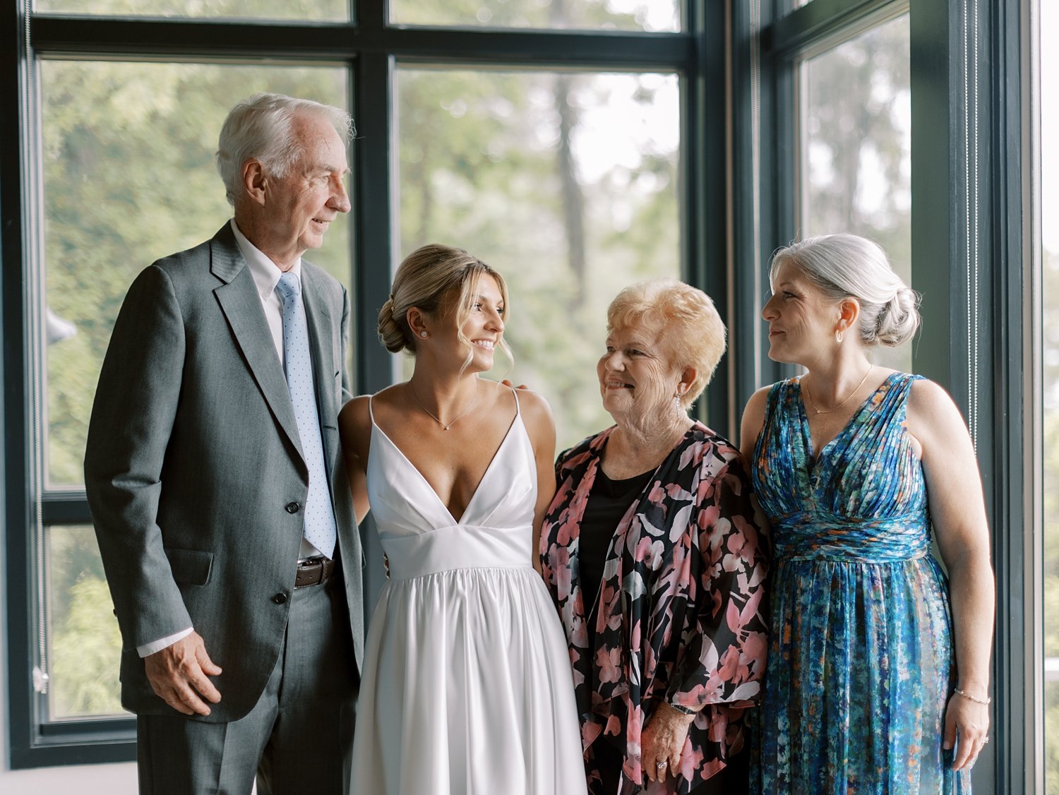 bride smiles with family on morning of wedding at the Buttermilk Inn &amp; Spa