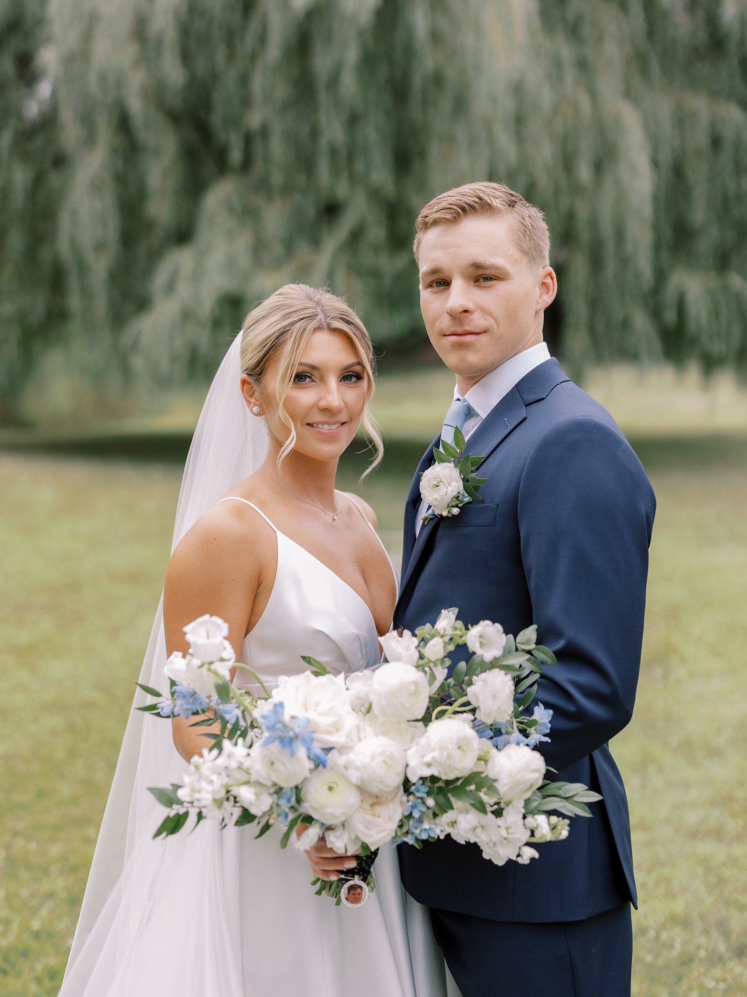 newlyweds hug in field at the Buttermilk Inn &amp; Spa