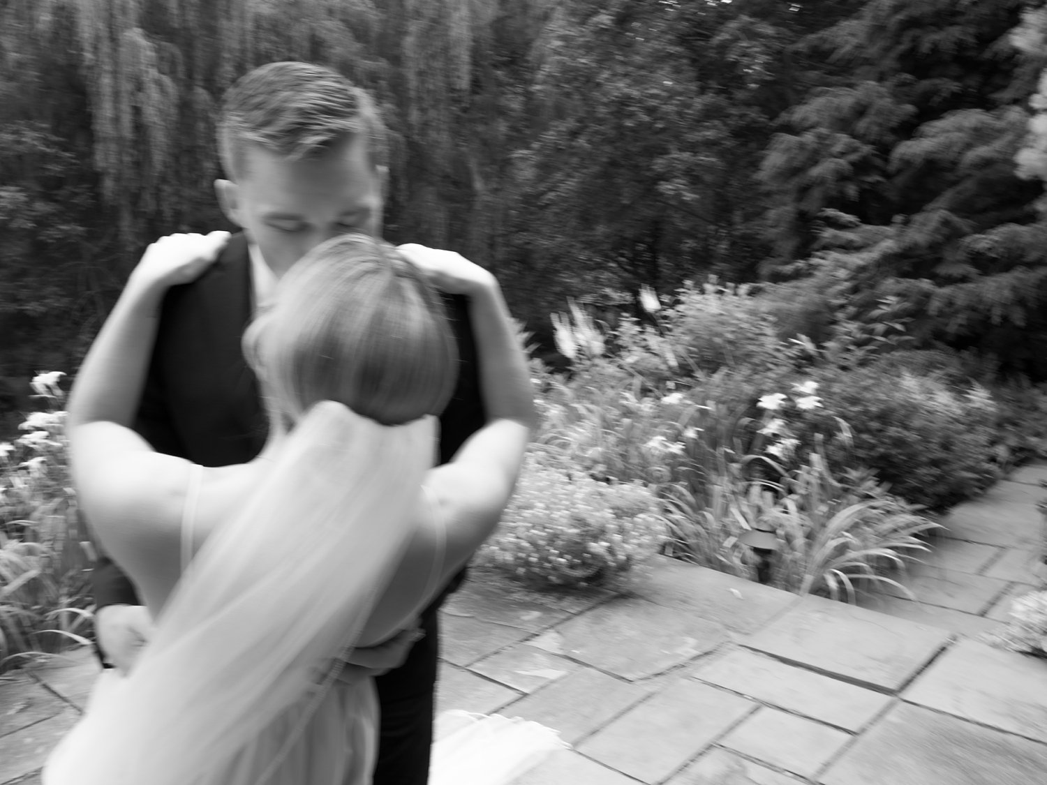 groom dips bride kissing her on patio at the Buttermilk Inn &amp; Spa