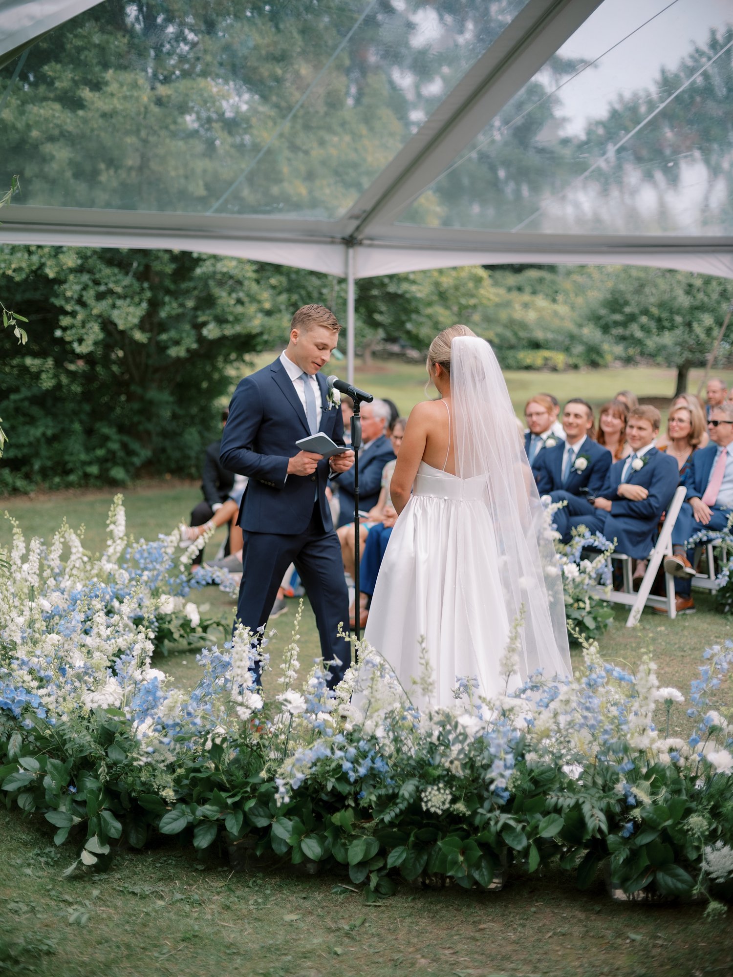 bride and groom read vows during wedding ceremony at the Buttermilk Inn &amp; Spa